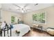 Bright bedroom featuring hardwood floors, large windows, and a cozy window seat, offering a peaceful retreat at 105 Spring St, Summerville, SC 29485
