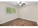 Cozy bedroom featuring laminate flooring, a ceiling fan, and natural light from a window at 105 Spring St, Summerville, SC 29485