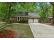 Charming brick home features a two-car garage and mature trees surrounding the property at 105 Spring St, Summerville, SC 29485