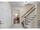 Bright foyer with staircase and a glimpse into the living room at 105 Spring St, Summerville, SC 29485