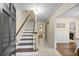 Inviting foyer with staircase, tile flooring, and view into the dining room at 105 Spring St, Summerville, SC 29485