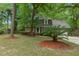 Charming front exterior of a brick house with mature trees and a well-maintained lawn at 105 Spring St, Summerville, SC 29485