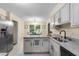Bright kitchen with stainless steel appliances, granite countertops, and a sink island at 105 Spring St, Summerville, SC 29485