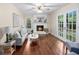 Spacious living room features a brick fireplace, hardwood floors, a ceiling fan, and natural light at 105 Spring St, Summerville, SC 29485