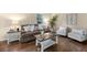 Cozy living room with sofa, chairs, and hardwood flooring, filled with natural light from the window at 105 Spring St, Summerville, SC 29485