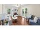 Inviting living room features a brick fireplace, hardwood floors, and French doors to the outside at 105 Spring St, Summerville, SC 29485