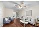 Bright living room boasts hardwood floors, a charming bookshelf, and comfortable seating, perfect for relaxation at 105 Spring St, Summerville, SC 29485