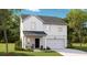 Charming two-story home featuring a covered porch, attached garage, and beautiful landscaping at 113 Pen Shell St, Summerville, SC 29485