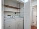 Laundry room closet with a washer, dryer, wooden shelf, and bi-fold doors at 1158 Village Creek Ln # 4, Mount Pleasant, SC 29464