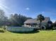 Backyard with above ground pool, lush lawn, palm tree, and view of the home at 1173 Penny Creek Dr, Ruffin, SC 29475