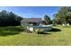 Backyard with above ground pool, lush lawn, and tropical landscaping at 1173 Penny Creek Dr, Ruffin, SC 29475