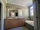 Bright bathroom with a corner tub, double vanity, and neutral tile flooring at 1173 Penny Creek Dr, Ruffin, SC 29475