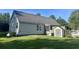 Home exterior featuring vinyl siding, backyard shed and manicured lawn at 1173 Penny Creek Dr, Ruffin, SC 29475