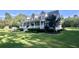 Well-maintained home with covered porch, dormer windows, lush lawn, and manicured landscaping at 1173 Penny Creek Dr, Ruffin, SC 29475