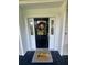 Close-up of a welcoming front door adorned with a wreath and charming 'hello' doormat at 1173 Penny Creek Dr, Ruffin, SC 29475