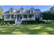Charming home featuring a covered front porch with a metal roof and manicured landscaping at 1173 Penny Creek Dr, Ruffin, SC 29475