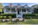 Charming home featuring a welcoming front porch, dormer windows, and mature landscaping at 1173 Penny Creek Dr, Ruffin, SC 29475