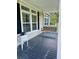 Inviting front porch with a classic swing and ample space to relax and enjoy the outdoors at 1173 Penny Creek Dr, Ruffin, SC 29475