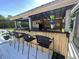 Outdoor bar area featuring a rustic design with seating and mini-fridge at 1173 Penny Creek Dr, Ruffin, SC 29475