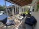 Inviting screened porch with comfortable seating, colorful rug, and bar in view at 1173 Penny Creek Dr, Ruffin, SC 29475