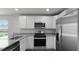 Bright kitchen featuring white cabinets, stainless steel appliances, and granite countertops at 143 Haventree Ct, Summerville, SC 29486