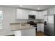 Bright kitchen featuring white cabinets, stainless steel appliances, and granite countertops at 143 Haventree Ct, Summerville, SC 29486