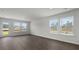 Spacious living room with wood flooring and ample natural light from a glass door and windows at 143 Haventree Ct, Summerville, SC 29486