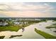 Stunning aerial view of waterfront community with marsh views and charming coastal homes under a blue sky at 1466 Mizzen Aly, Johns Island, SC 29455
