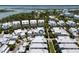 Expansive aerial view of modern white residences, highlighting community living amidst lush landscaping and waterfront scenery at 1466 Mizzen Aly, Johns Island, SC 29455