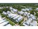 Breathtaking aerial view of a charming neighborhood featuring elegant white homes and lush greenery near a river at 1466 Mizzen Aly, Johns Island, SC 29455