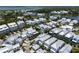 Picturesque aerial view of a coastal community featuring elegant white homes nestled around a tranquil lake at 1466 Mizzen Aly, Johns Island, SC 29455