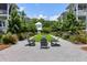 Scenic backyard featuring Adirondack chairs, lush landscaping, and charming pathway at 1466 Mizzen Aly, Johns Island, SC 29455