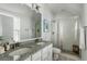 Bright bathroom with double vanity, granite countertop, and glass-enclosed shower at 1466 Mizzen Aly, Johns Island, SC 29455
