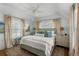 Bright bedroom boasts plush bedding, soft neutral decor, and ample natural light at 1466 Mizzen Aly, Johns Island, SC 29455