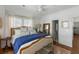 Bright bedroom features a cozy bed with blue accents, white walls, and hardwood floors at 1466 Mizzen Aly, Johns Island, SC 29455