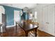 Open dining area features hardwood floors, blue accent wall, and stylish pendant lighting at 1466 Mizzen Aly, Johns Island, SC 29455