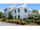 Beautiful home exterior with blue shutters, white siding, and lush landscaping at 1466 Mizzen Aly, Johns Island, SC 29455