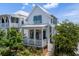 Beautiful two-story home with white siding, a charming porch, and vibrant landscaping at 1466 Mizzen Aly, Johns Island, SC 29455