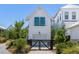 Stylish home featuring white siding, blue shutters, and an inviting entrance with a black gate at 1466 Mizzen Aly, Johns Island, SC 29455