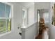 Light-filled hallway with hardwood floors and bright windows with charming shutters at 1466 Mizzen Aly, Johns Island, SC 29455