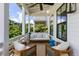 Inviting covered porch featuring stylish seating and serene outdoor views at 1466 Mizzen Aly, Johns Island, SC 29455