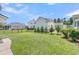Expansive backyard features lush green grass, complemented by manicured landscaping and a classic black metal fence at 1601 Bourne Xing, Mount Pleasant, SC 29466