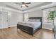 Light and airy bedroom featuring wood floors, tray ceiling, and large windows at 1601 Bourne Xing, Mount Pleasant, SC 29466