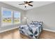 Cozy bedroom with light gray walls, wood floor, and bright, natural light from the windows at 1601 Bourne Xing, Mount Pleasant, SC 29466