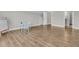 Open-concept bedroom with light gray walls, hardwood floors, and an adjacent bathroom and closet at 1601 Bourne Xing, Mount Pleasant, SC 29466