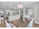 Bright open-concept space with dining table, chairs, pendant lighting and views of the kitchen and living room at 1601 Bourne Xing, Mount Pleasant, SC 29466