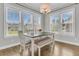 Cozy dining area filled with natural light, featuring a modern table, chairs, bench, and stylish light fixture at 1601 Bourne Xing, Mount Pleasant, SC 29466