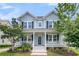 Two-story home featuring a covered front porch with white columns, black shutters, and manicured landscaping at 1601 Bourne Xing, Mount Pleasant, SC 29466