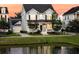 Charming two-story home with a well-manicured lawn and a pond in the front yard, perfect for suburban living at 1601 Bourne Xing, Mount Pleasant, SC 29466