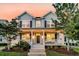Charming home featuring a covered front porch with white columns, black shutters, and manicured landscaping at 1601 Bourne Xing, Mount Pleasant, SC 29466